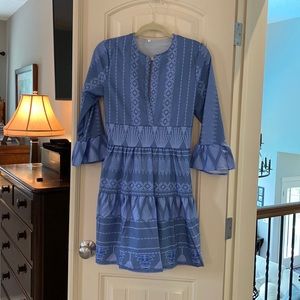 Blue dress with long, flair sleeves and low cut front.